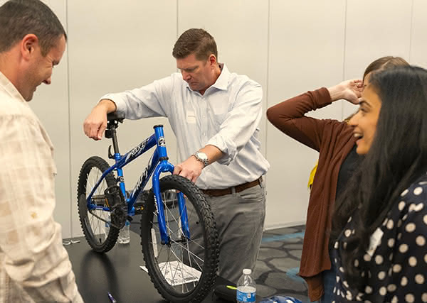F&G leaders building bikes for kids.